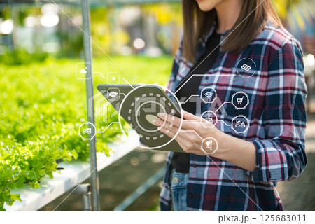 Smart farmer using application by tablet concepts modern agricultural technology and visual icon. Smart farmer using application by tablet concepts modern agricultural technology and visual icon. 125683011