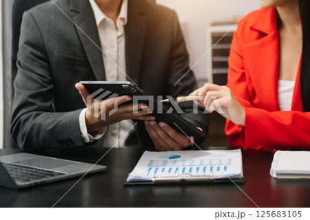 Team work process. Photo young business crew working with new startup project. Project managers meeting. Analyze plans, papers. At office Team work process. Photo young business crew working with new startup project. Project managers meeting. Analyze plans, papers. At office 125683105