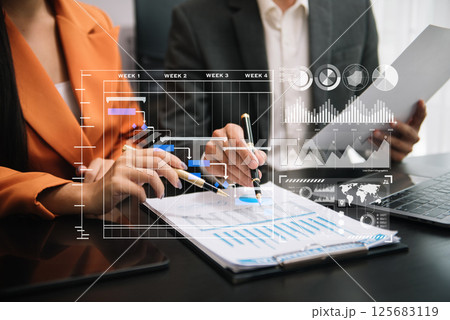Business team hand Project manager working and update tasks and Gantt chart scheduling virtual diagram.with smart phone, tablet and laptop in office. 125683119