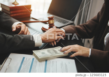 business people and lawyers discussing contract papers sitting at the table. Concepts of law, advice, legal services. in morning light business people and lawyers discussing contract papers sitting at the table. Concepts of law, advice, legal services. in morning light 125683123