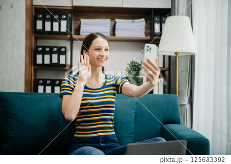 Caucasian businesswoman working in the office with working notepad, tablet and laptop documents on sofa in home office Caucasian businesswoman working in the office with working notepad, tablet and laptop documents on sofa in home office 125683392
