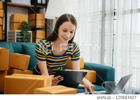 Small business entrepreneur SME freelance woman working at home office, BOX,tablet and laptop online, marketing, packaging, delivery Small business entrepreneur SME freelance woman working at home office, BOX,tablet and laptop online, marketing, packaging, delivery 125683427