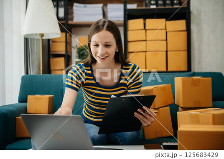 Small business entrepreneur SME freelance woman working at home office, BOX,tablet and laptop online, marketing, packaging, delivery 125683429