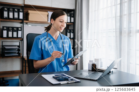 Medical technology concept. woman Doctor working with mobile phone and stethoscope in modern office Medical technology concept. woman Doctor working with mobile phone and stethoscope in modern office 125683645