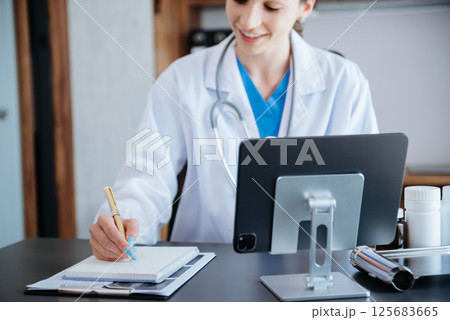 Medical technology concept. Doctor working with mobile phone and stethoscope in modern office 125683665
