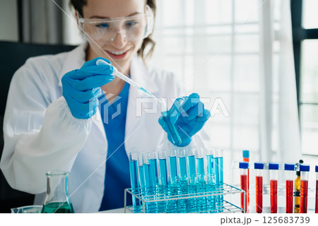 Modern medical research laboratory. female scientist working with micro pipettes analyzing biochemical samples, advanced science chemical laboratory for medicine. 125683739