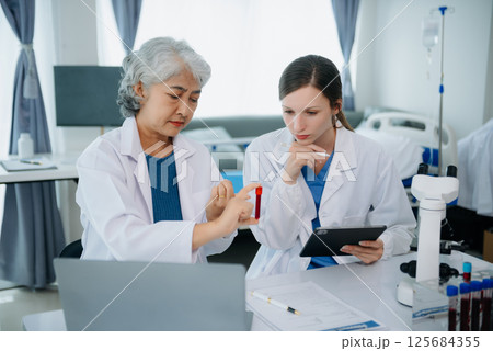 Medical team having a meeting with doctors. Young scientists conducting research investigations 125684355