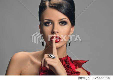 Woman touching lips 125684890