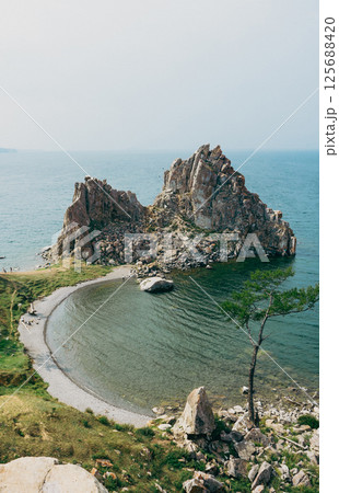 Shamanka rock, Burkhan cape, Olkhon Island in Baikal lake. Summer natural landscape Shamanka rock, Burkhan cape, Olkhon Island in Baikal lake. Summer natural landscape 125688420