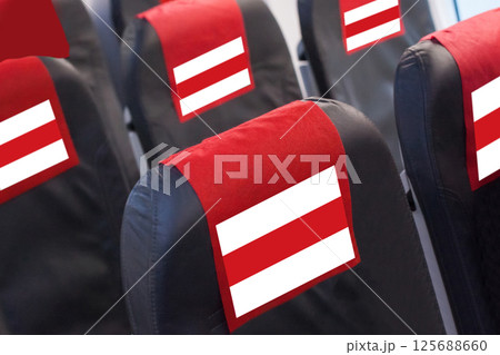 Red and white Flag on Empty seat in plane. Travel, flight and transportration in Belarus concept Red and white Flag on Empty seat in plane. Travel, flight and transportration in Belarus concept 125688660