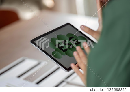 ESG sustainability focus with digital tablet displaying ESG concept ESG sustainability focus with digital tablet displaying ESG concept 125688832