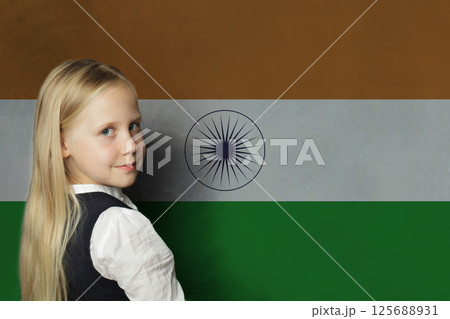 Cute young child girl on flag of India background. Education and study language concept 125688931