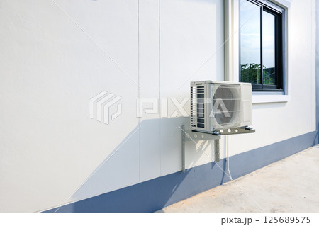 Condenser unit outside home. 125689575