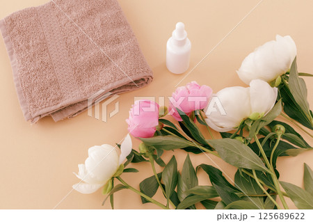 Spa products for facial and body care. Soft terry towel with serum. Spa products for facial and body care. Soft terry towel with serum. 125689622