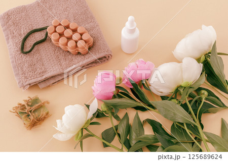 Spa products for facial and body care. Soft terry towel with soap and serum. 125689624