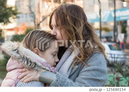 Loving woman hugging child. Mother and daughter together. Childhood, happiness, love and family 125690154