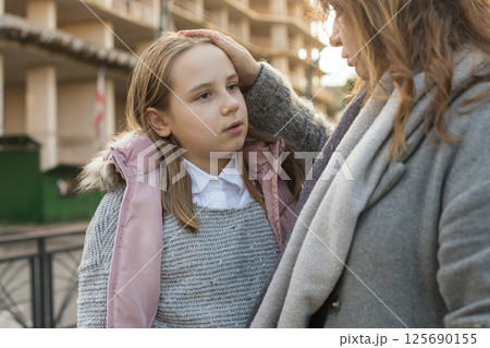 Woman hugging child. Mother and daughter together. Childhood, happiness, love and family concept 125690155