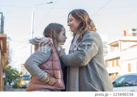 Loving family. Playful child girl and happy mother, outdoors portrait 125690156