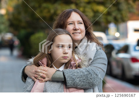 Happy woman hugging child. Mother and daughter together. Childhood, happiness Happy woman hugging child. Mother and daughter together. Childhood, happiness 125690167