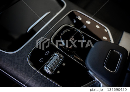 Automatic transmission selector in the interior of a modern car. 125690420