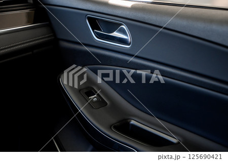 Car door with door handle and window control and adjustment button Car door with door handle and window control and adjustment button 125690421