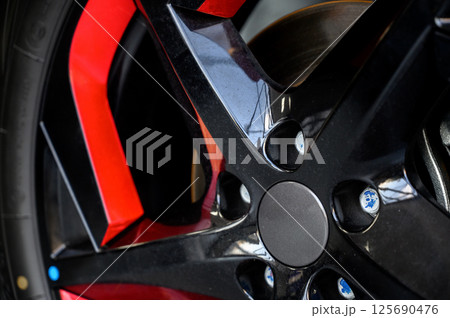 Car wheel with brake calipers and stylish design. 125690476