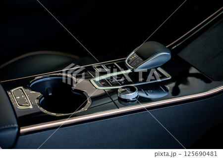 Automatic transmission selector in the interior of a modern car. 125690481