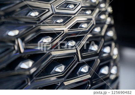 Close-up of the facade of a new car in a car showroom. The radiator grille of a car 125690482