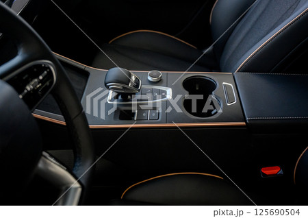 Automatic transmission selector in the interior of a modern car. 125690504