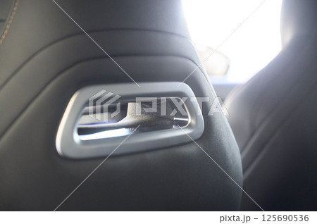 Close-up of black leather seat of modern car Close-up of black leather seat of modern car 125690536