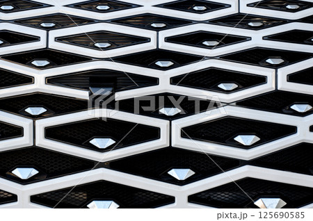 Close-up of the facade of a new car in a car showroom. The radiator grille of a car Close-up of the facade of a new car in a car showroom. The radiator grille of a car 125690585