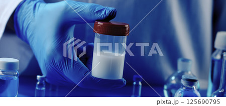 man holding a container with semen, banner 125690795