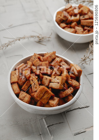 diced marinated tofu in a pair of white bowls 125690806