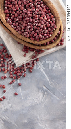 Bowls full of dried azuki beans on gray top view. Vegetarian protein source, East Asian legumes 125694199