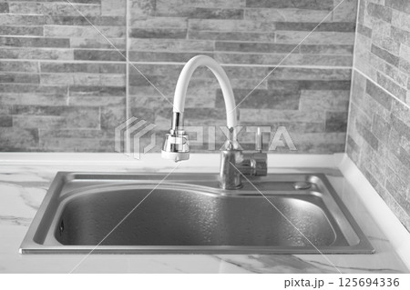 Close up of tap water in the kitchen Close up of tap water in the kitchen 125694336