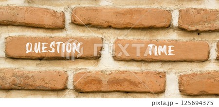 Question time symbol. Concept words Question time on beautiful brown brick wall. Beautiful brown brick wall background. Business and question time concept. Copy space. 125694375