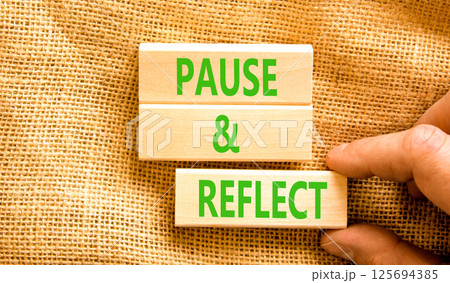 Pause and reflect symbol. Concept words Pause and reflect on beautiful block. Businessman's hand. Beautiful canvas background. Business motivational lifestyle pause and reflect concept. Copy space. Pause and reflect symbol. Concept words Pause and reflect on beautiful block. Businessman's hand. Beautiful canvas background. Business motivational lifestyle pause and reflect concept. Copy space. 125694385