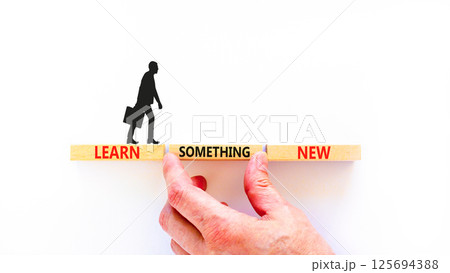 Learn something new symbol. Concept words Learn something new on beautiful block. Businessman's hand. Beautiful white background Business motivational lifestyle learn something new concept Copy space 125694388