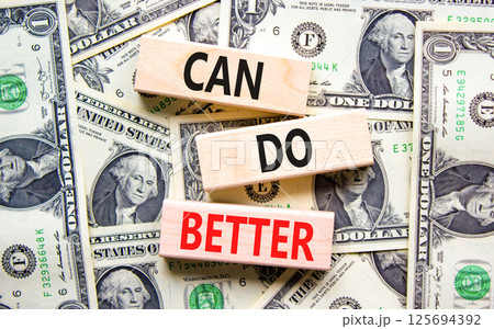 Can do better symbol. Concept words Can do better on beautiful wooden blocks. Dollar bills. Beautiful background from dollar bills. Business and can do better concept. Copy space. 125694392