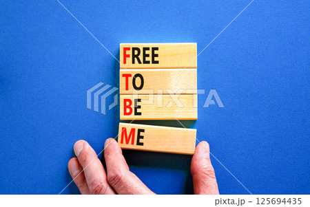 FTBM Free To Be Me symbol. Concept word FTBM Free To Be Me on beautiful wooden blocks. Beautiful blue background. Business motivational FTBM Free To Be Me concept. Copy space. 125694435