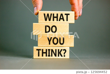 What do you think symbol. Concept words What do you think on beautiful wooden blocks. Beautiful grey table grey background. Businessman hand. Business and What do you think concept. Copy space. 125694452