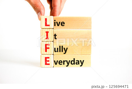 LIFE live it fully everyday symbol. Concept word LIFE Live It Fully Everyday on beautiful blocks. Beautiful white background. Business motivational LIFE live it fully everyday concept. Copy space. 125694471