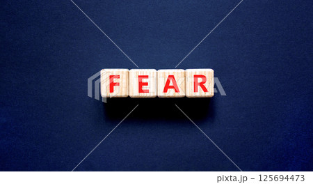 Fear symbol. Concept word Fear on beautiful wooden blocks. Beautiful black table black background. Business, lifestyle and fear concept. Copy space. Fear symbol. Concept word Fear on beautiful wooden blocks. Beautiful black table black background. Business, lifestyle and fear concept. Copy space. 125694473