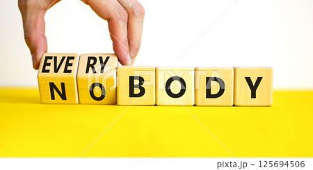 Everybody vs nobody symbol. Concept words Everybody and Nobody on wooden cubes. Beautiful yellow table white background. Businessman hand. Business and everybody vs nobody concept. Copy space. Everybody vs nobody symbol. Concept words Everybody and Nobody on wooden cubes. Beautiful yellow table white background. Businessman hand. Business and everybody vs nobody concept. Copy space. 125694506