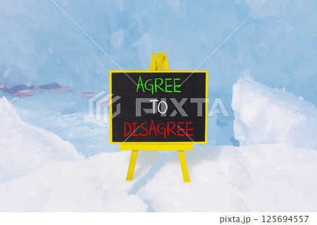 Agree to disagree symbol. Concept words Agree to disagree on beautiful blackboard. Beautiful blue ice and snow background. Business and agree to disagree concept. Copy space. Agree to disagree symbol. Concept words Agree to disagree on beautiful blackboard. Beautiful blue ice and snow background. Business and agree to disagree concept. Copy space. 125694557