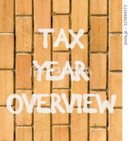 Tax year overview symbol. Concept words Tax year overview on beautiful brown brick wall. Beautiful brown brick wall background. Business tax year overview concept. Copy space. 125694572