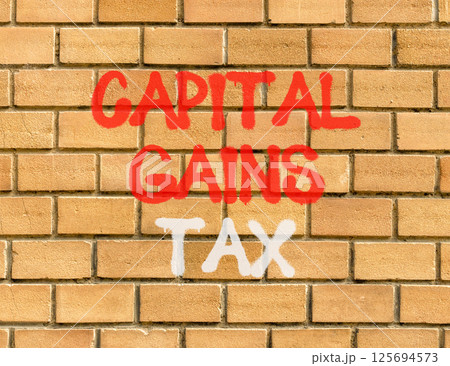 Capital gains tax symbol. Concept words Capital gains tax on beautiful brick wall . Beautiful brick wall background. Business and capital gains tax concept. Copy space. 125694573