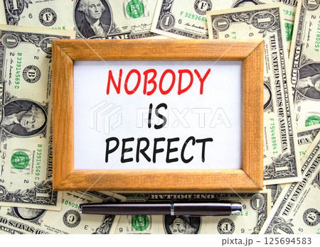 Nobody is perfect symbol. Concept words Nobody is perfect on beautiful picture frame. Beautiful background from dollar bills. Business motivational lifestyle and nobody is perfect concept. Copy space. 125694583