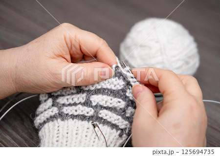 female hands knitting close up female hands knitting close up 125694735