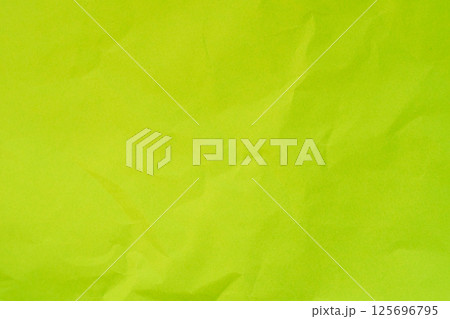 Textured light green color crumpled paper background 125696795